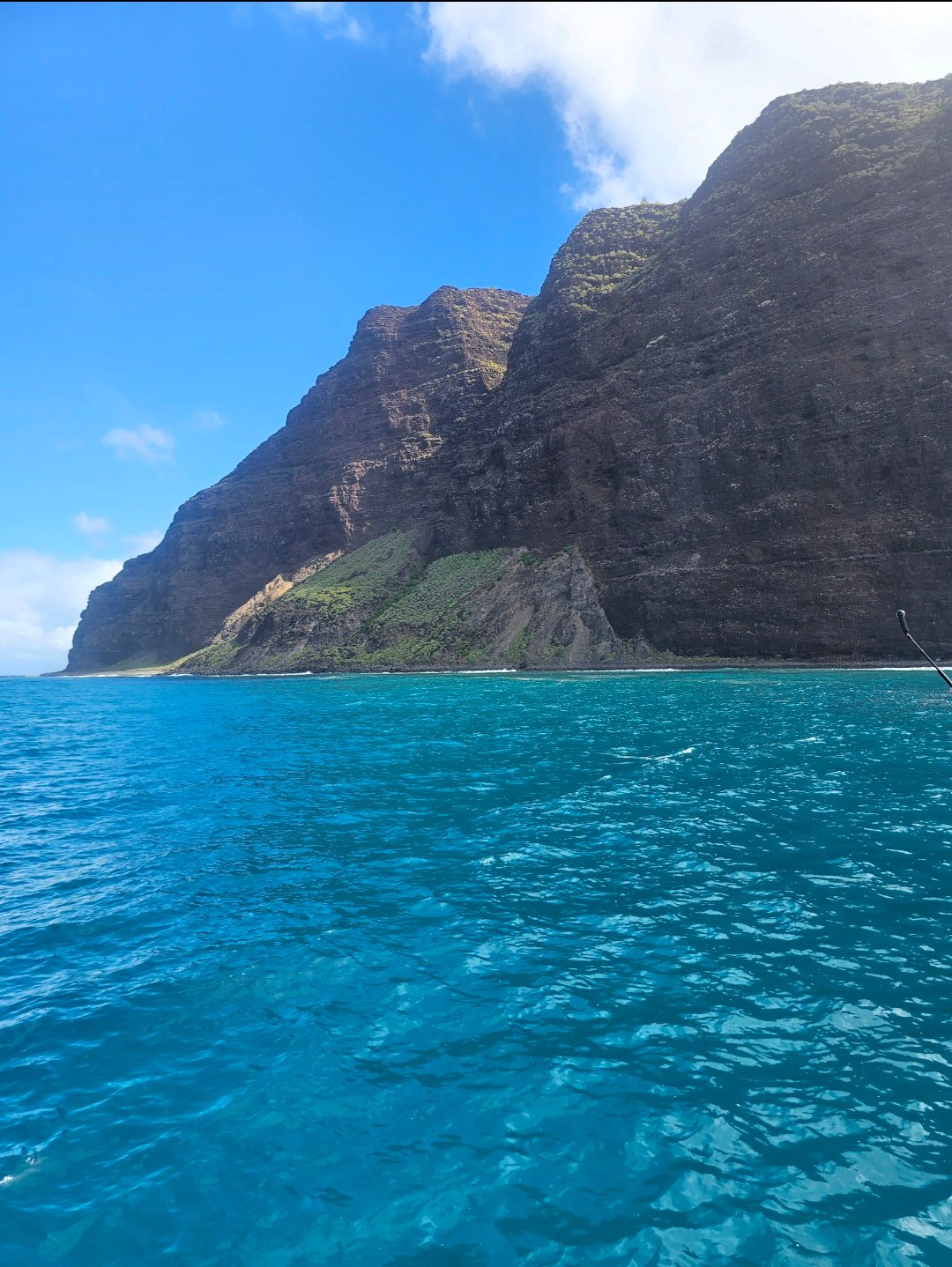 Home Na Pali Coast cliffs on Kauai with turquoise ocean